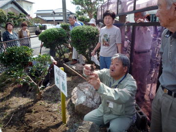 市民センターの花壇で球根の植え方を指導される伊藤さん